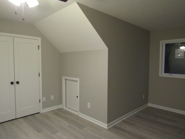 additional living space featuring ceiling fan, light hardwood / wood-style flooring, and lofted ceiling