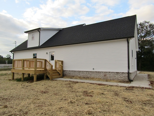 back of house with a wooden deck