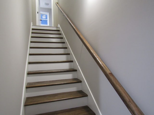 stairs featuring hardwood / wood-style floors