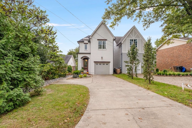 view of front of home with a front yard and a garage