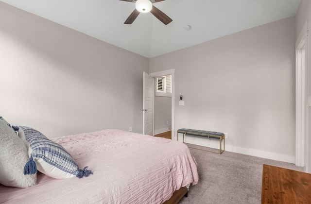 bedroom featuring carpet flooring, vaulted ceiling, and ceiling fan