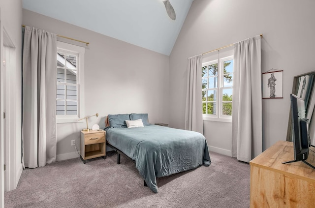 carpeted bedroom featuring ceiling fan and high vaulted ceiling