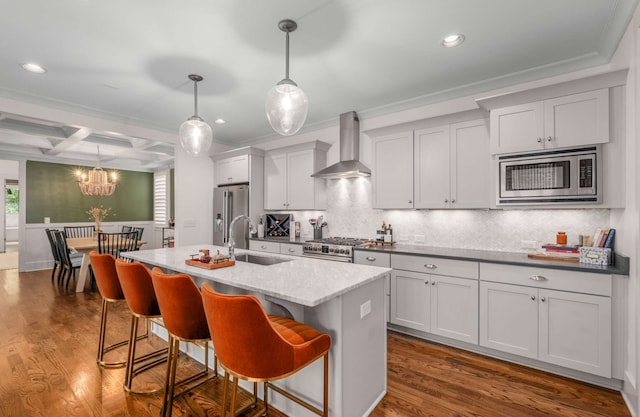 kitchen featuring a kitchen island with sink, wall chimney exhaust hood, dark hardwood / wood-style flooring, and appliances with stainless steel finishes