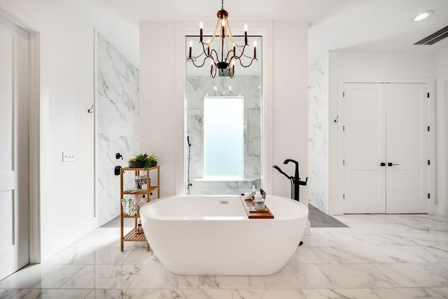 bathroom featuring a tub and a notable chandelier