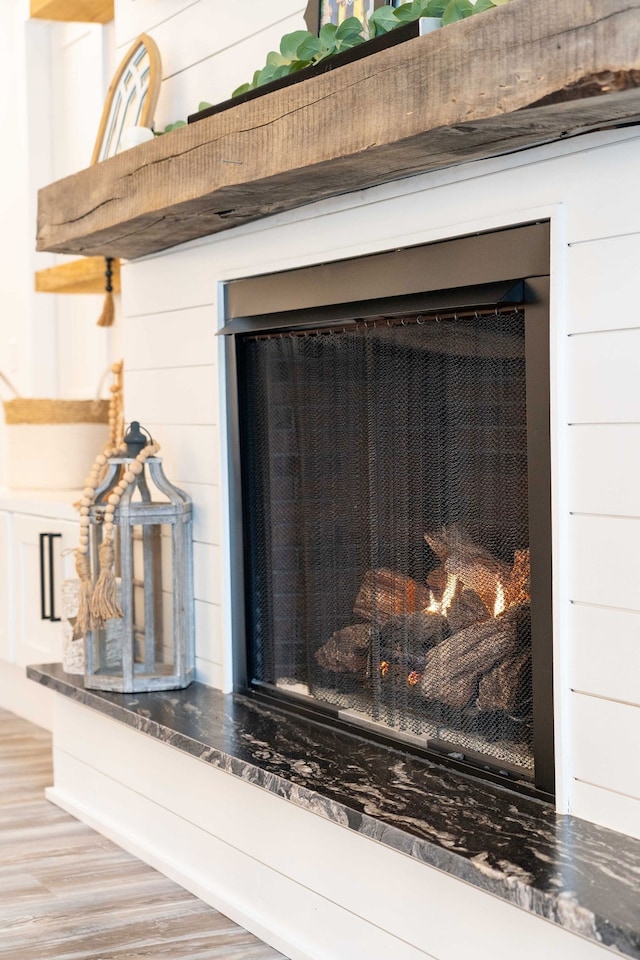 room details with hardwood / wood-style floors and wooden walls