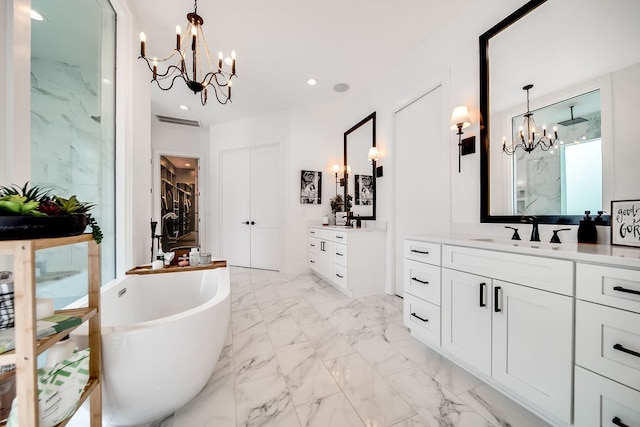 bathroom with vanity, a chandelier, and separate shower and tub