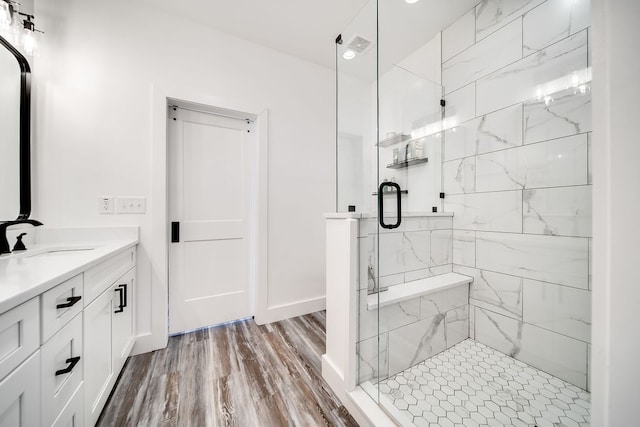 bathroom featuring vanity, hardwood / wood-style flooring, and walk in shower