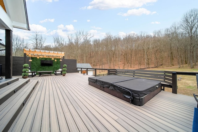 wooden deck with a covered hot tub