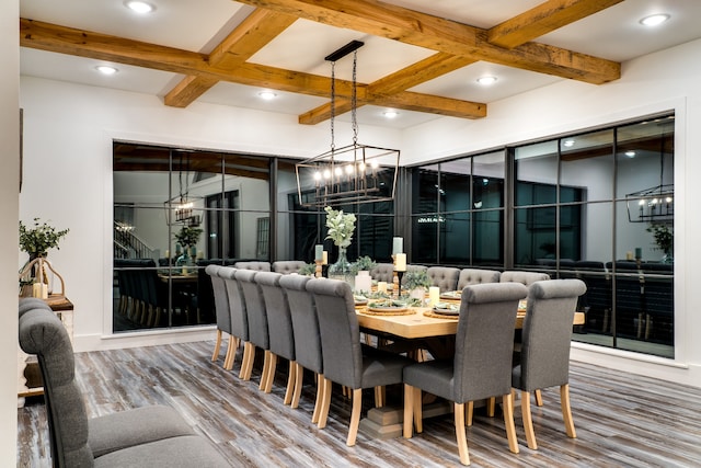 dining area with a notable chandelier, hardwood / wood-style floors, beam ceiling, and coffered ceiling