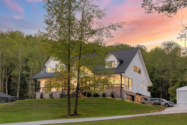 modern inspired farmhouse with a yard