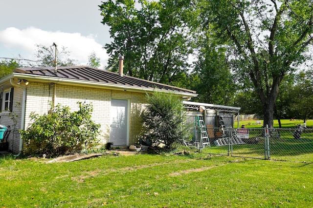 rear view of house featuring a lawn