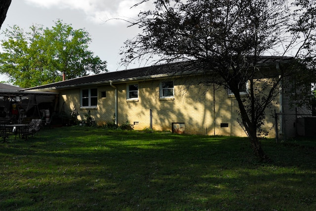 rear view of property with a lawn