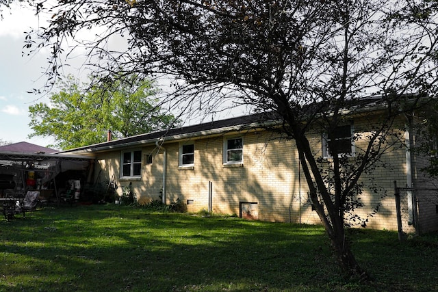 rear view of house featuring a lawn