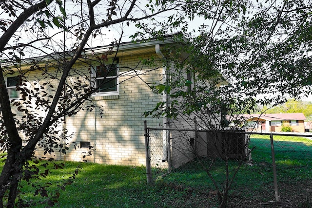 view of side of home featuring a yard