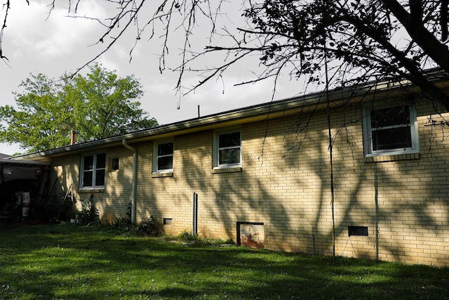 view of side of home featuring a yard