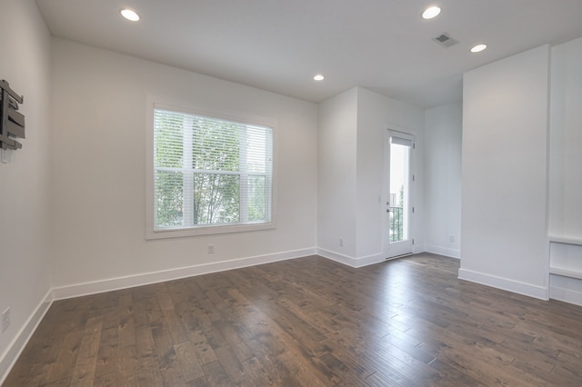 unfurnished room with dark hardwood / wood-style flooring