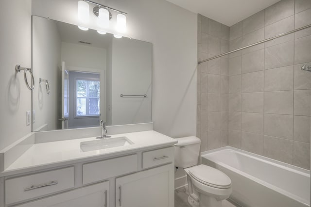 full bathroom with tiled shower / bath combo, vanity, and toilet