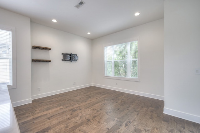 spare room featuring dark hardwood / wood-style flooring