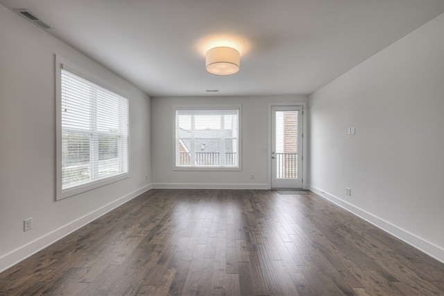 empty room with dark hardwood / wood-style flooring