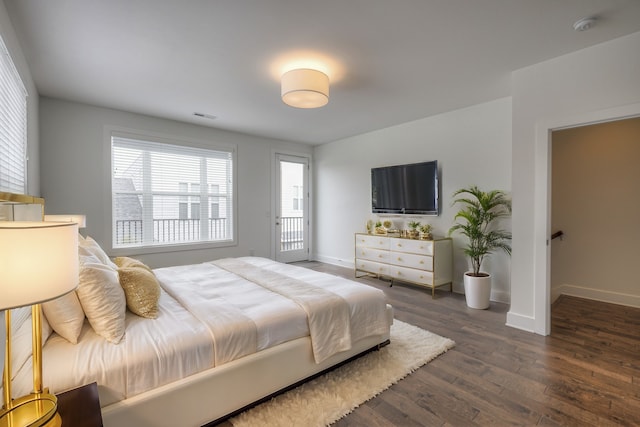 bedroom with dark hardwood / wood-style flooring