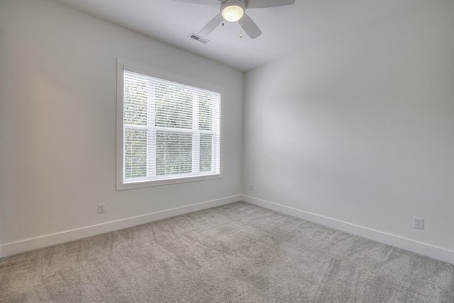 carpeted empty room featuring ceiling fan