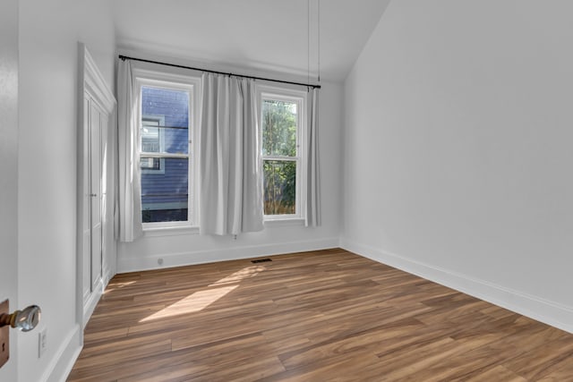 spare room with dark wood-type flooring