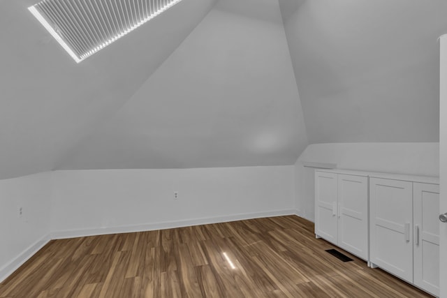 bonus room with hardwood / wood-style flooring and lofted ceiling