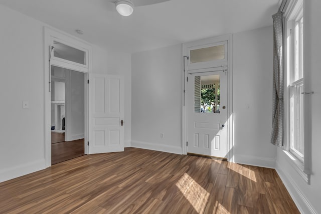 spare room featuring dark hardwood / wood-style floors and a fireplace