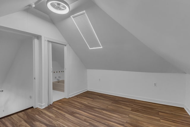 bonus room with vaulted ceiling and dark hardwood / wood-style floors