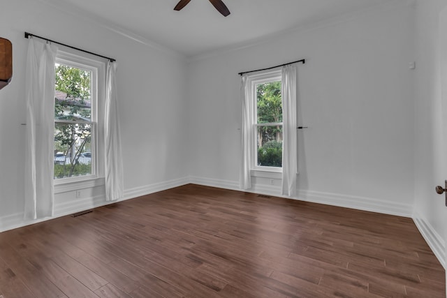 spare room with ceiling fan, dark wood-type flooring, and ornamental molding