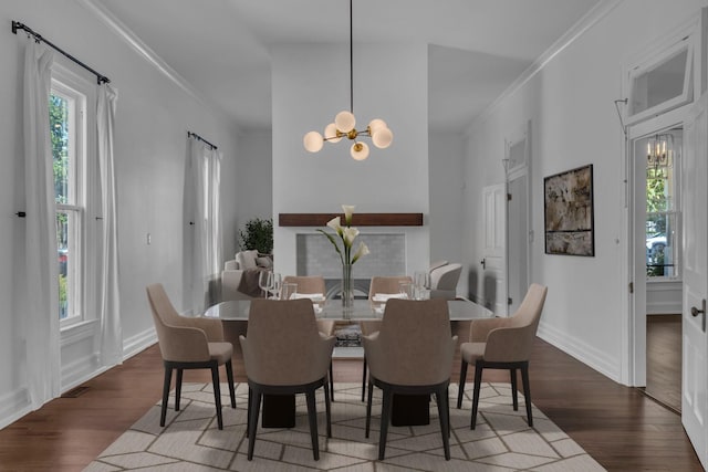 dining space featuring a notable chandelier, plenty of natural light, and dark hardwood / wood-style floors