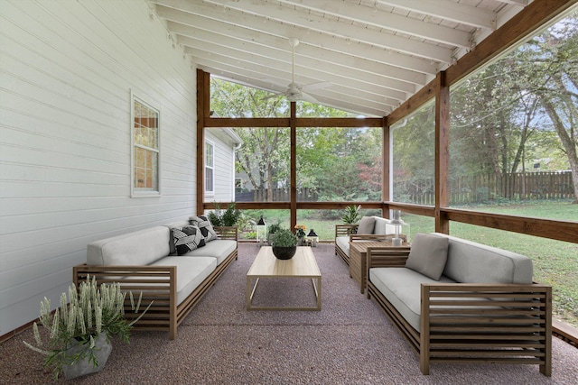 sunroom featuring vaulted ceiling with beams and ceiling fan