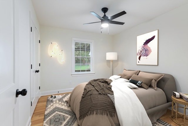 bedroom with light hardwood / wood-style floors and ceiling fan