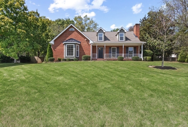 new england style home with a front lawn and a porch