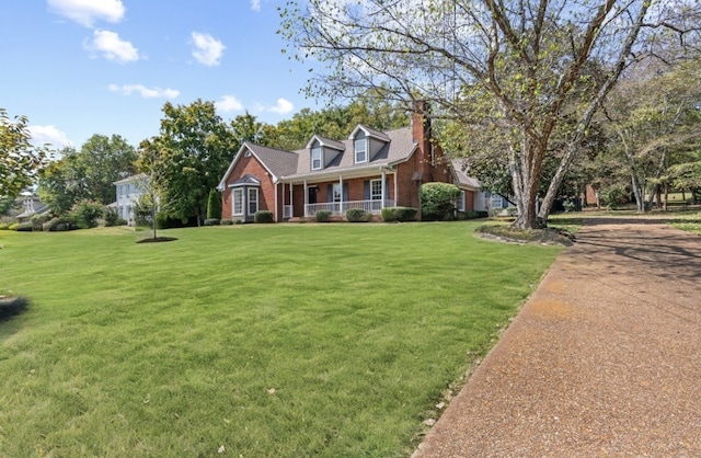 cape cod-style house with a front lawn