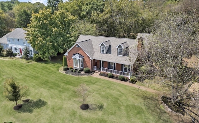 cape cod house with a front yard and a porch