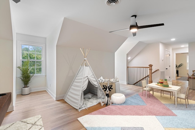 recreation room featuring ceiling fan and light hardwood / wood-style floors