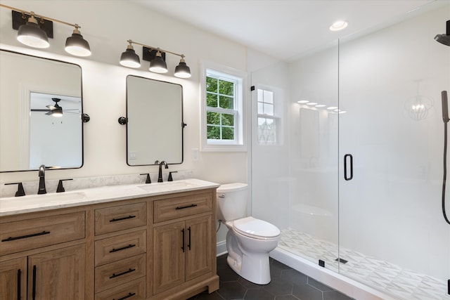 bathroom featuring tile patterned flooring, walk in shower, ceiling fan, vanity, and toilet