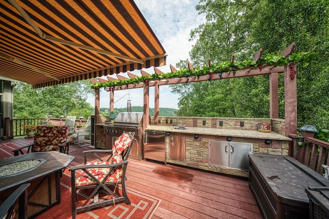 wooden deck featuring a grill and exterior kitchen