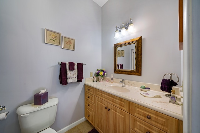 bathroom featuring vanity, tile patterned flooring, and toilet