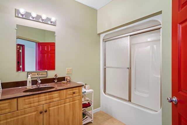 bathroom featuring enclosed tub / shower combo, tile patterned floors, and vanity