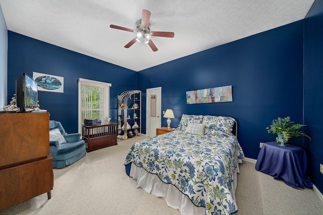 bedroom with a textured ceiling, carpet, and ceiling fan