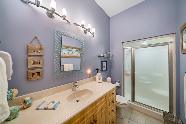 bathroom with vanity, toilet, tile patterned floors, and a shower with door