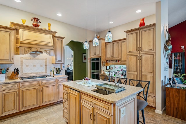 kitchen with tasteful backsplash, decorative light fixtures, appliances with stainless steel finishes, a kitchen breakfast bar, and a center island