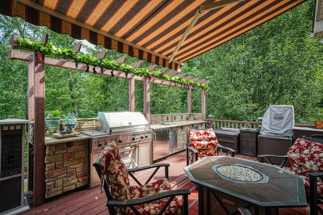 deck featuring area for grilling and a fire pit