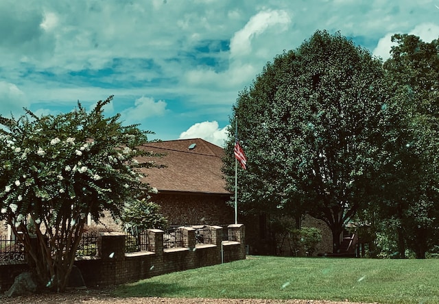 view of side of home featuring a yard and a patio area