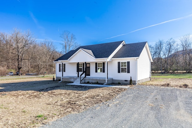 view of front of property with covered porch, roof with shingles, and crawl space