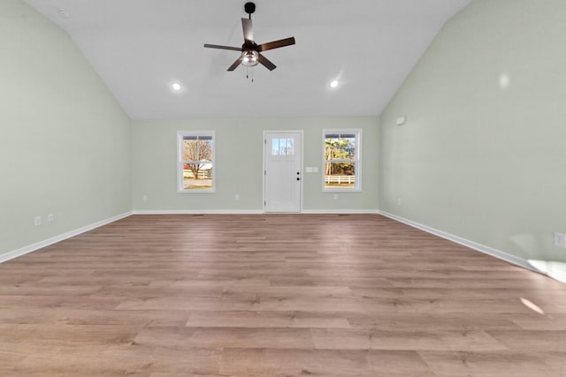 unfurnished living room featuring a ceiling fan, a healthy amount of sunlight, baseboards, and wood finished floors