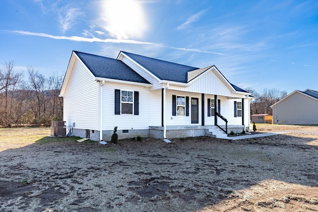 view of front of house with crawl space, a shingled roof, a porch, and cooling unit