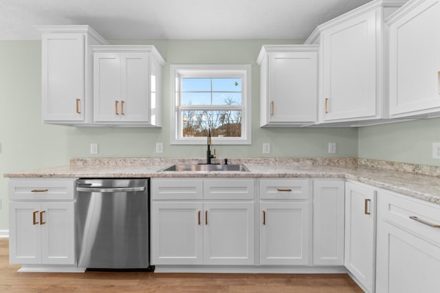 kitchen with light wood-style floors, white cabinets, a sink, and stainless steel dishwasher